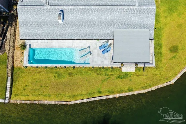 a view of a swimming pool and lounge chairs