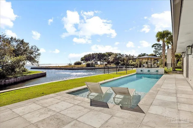an aerial view of house with yard swimming pool and outdoor seating