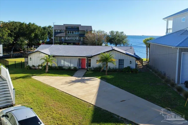 an aerial view of a house with a yard and potted plants