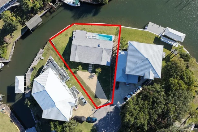 an aerial view of a house with a garden and swimming pool