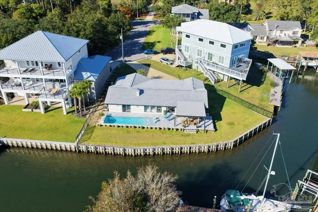 an aerial view of a house with outdoor space lake view and lake view
