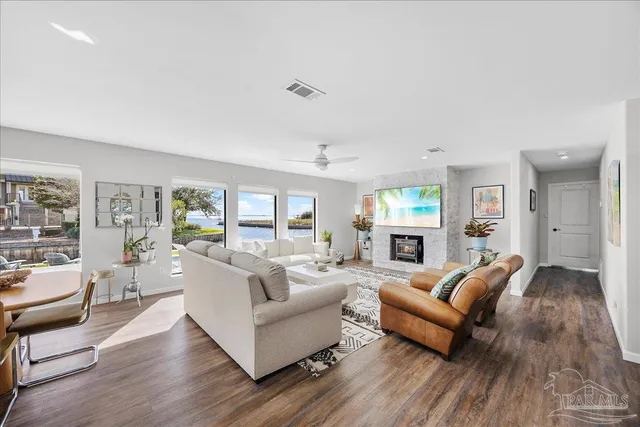 a living room with fireplace furniture and a wooden floor