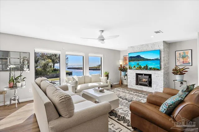 a living room with furniture a fireplace and a flat screen tv