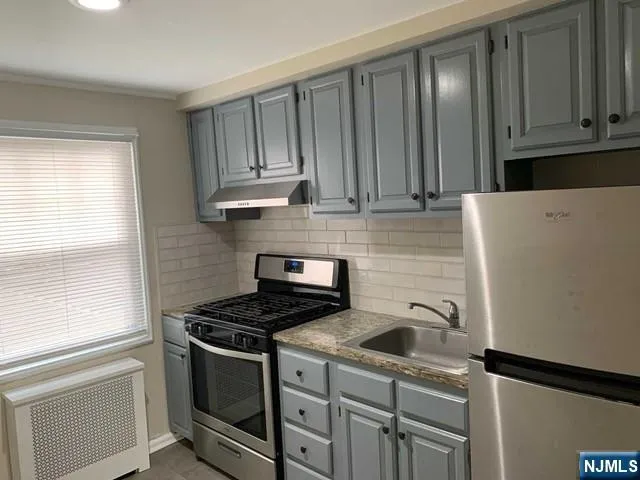 a kitchen with a sink stove and cabinets