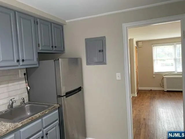 a kitchen with stainless steel appliances granite countertop a refrigerator sink and cabinets