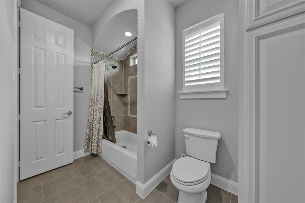 1060 Waters Edge Court Oak Point, TX 75068 - Photo 12 of 40 a bathroom with a toilet shower and a sink