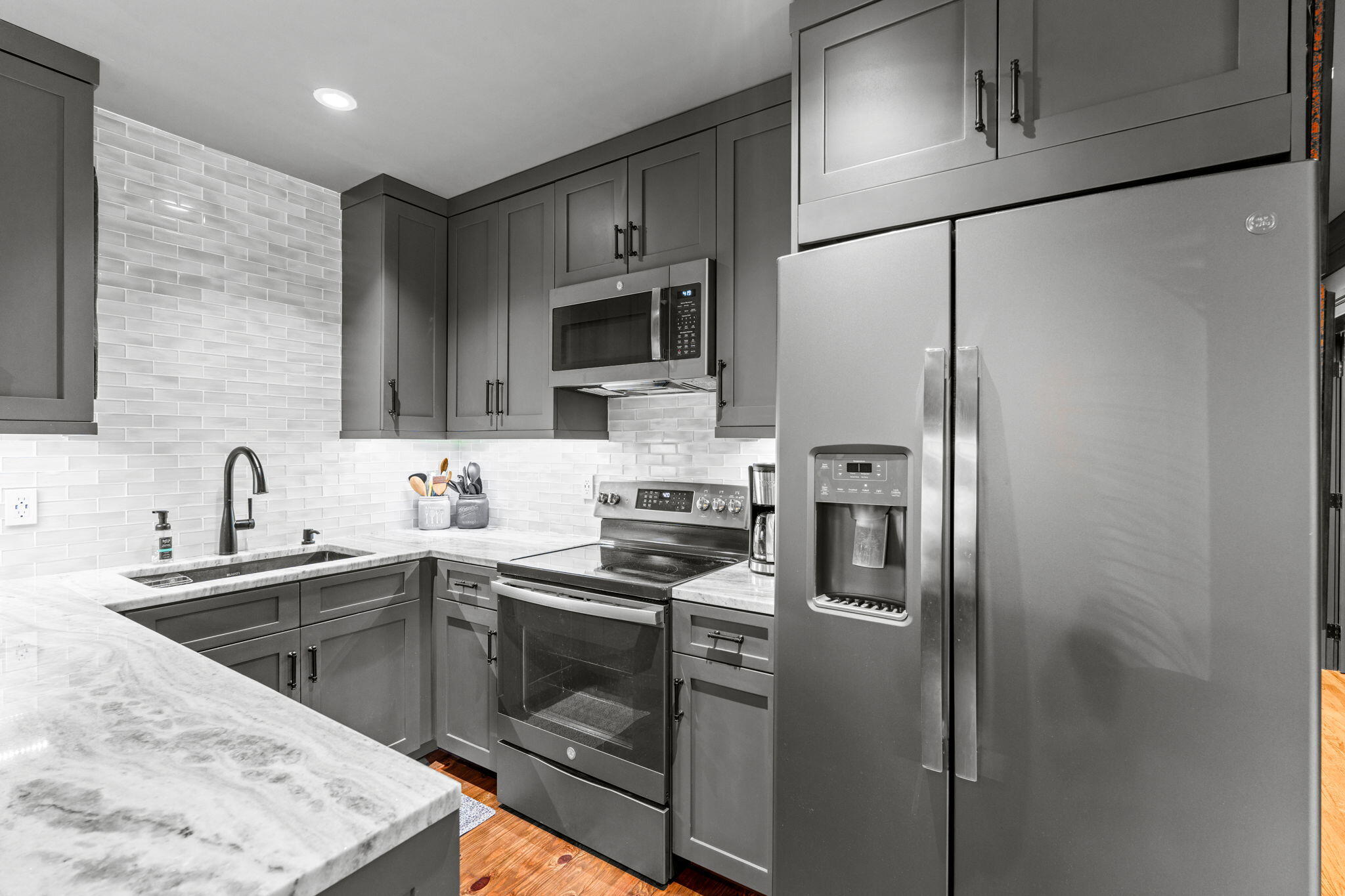 236 West 24th Street Riviera Beach, FL 33404 - Photo 11 of 48 a kitchen with stainless steel appliances granite countertop a sink stove and refrigerator