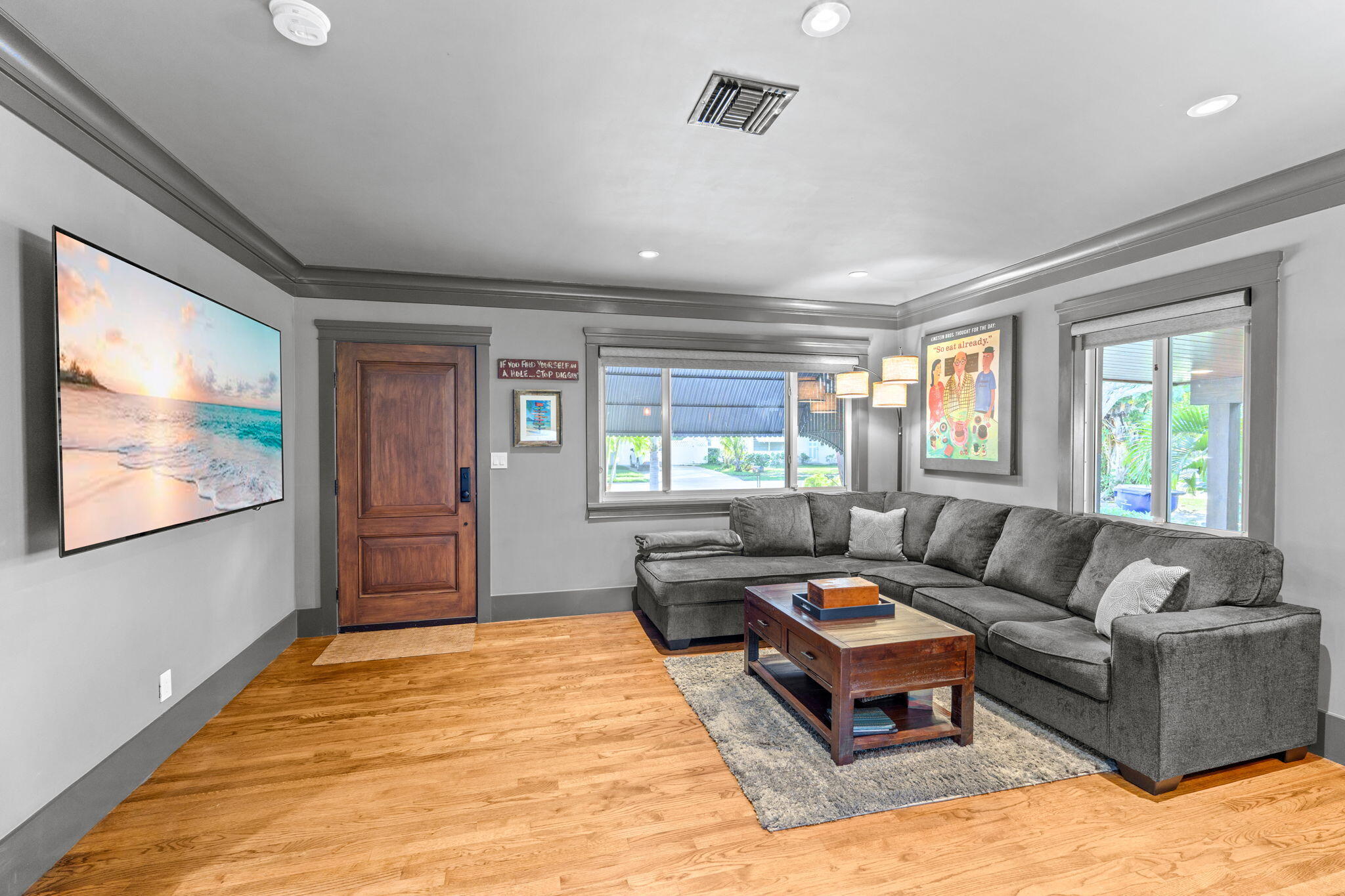 236 West 24th Street Riviera Beach, FL 33404 - Photo 6 of 48 a living room with furniture flat screen tv and a large window