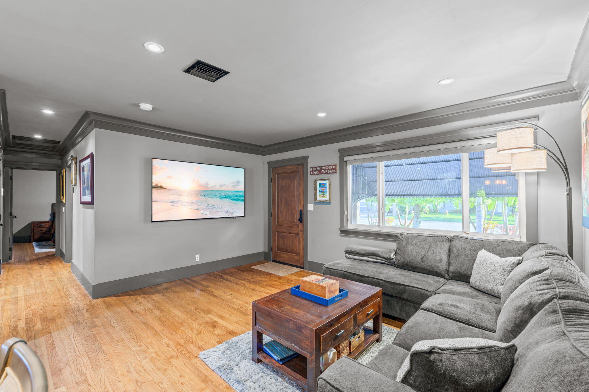 236 West 24th Street Riviera Beach, FL 33404 - Photo 7 of 48 a living room with furniture a flat screen tv and a large window