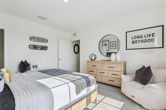 a bedroom with a bed and a dresser