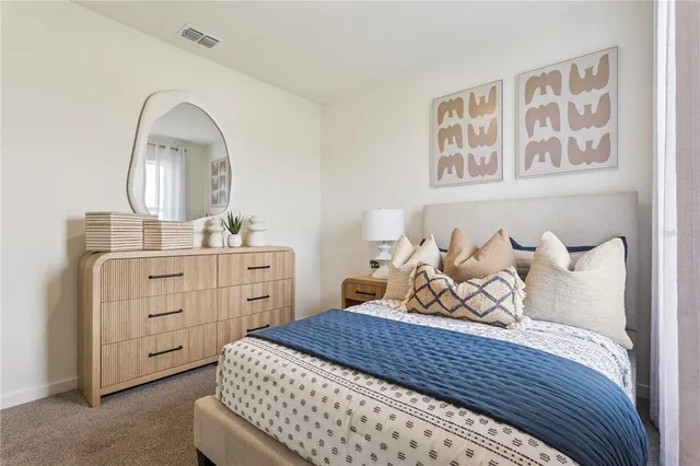 a bedroom with a bed and a dresser