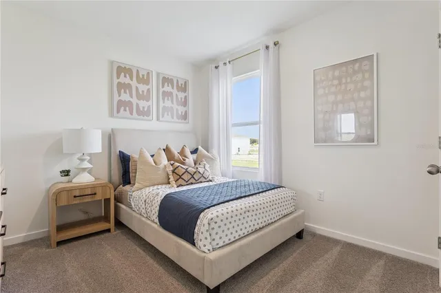 a bedroom with a bed and a night stand