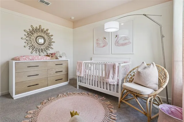 a room with a baby crib and a dresser