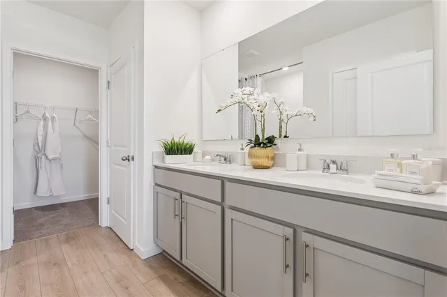 a bathroom with a double vanity sink and mirror