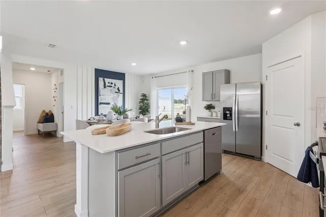 a kitchen with a sink appliances and cabinets