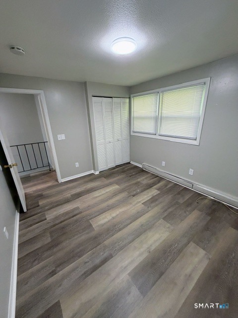 351 Mill Rock Road, Unit 351 Hamden, CT 06517 - Photo 11 of 13 an empty room with wooden floor and windows