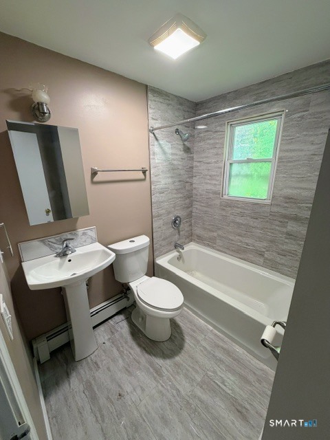 351 Mill Rock Road, Unit 351 Hamden, CT 06517 - Photo 12 of 13 a bathroom with a toilet a sink and bathtub