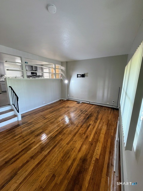 351 Mill Rock Road, Unit 351 Hamden, CT 06517 - Photo 2 of 13 a view of empty room with wooden floor