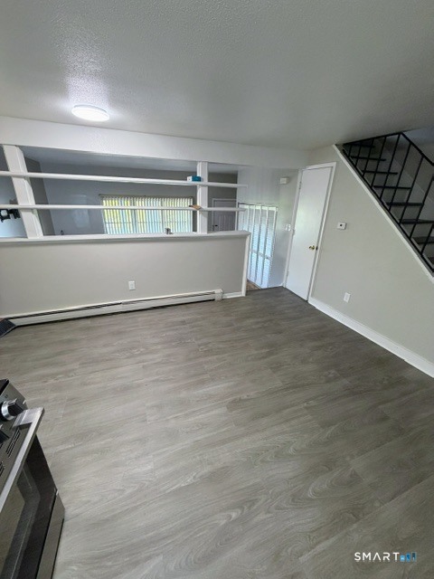 351 Mill Rock Road, Unit 351 Hamden, CT 06517 - Photo 5 of 13 a view of kitchen and empty room with wooden floor