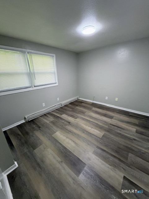 351 Mill Rock Road, Unit 351 Hamden, CT 06517 - Photo 10 of 13 an empty room with wooden floor and windows
