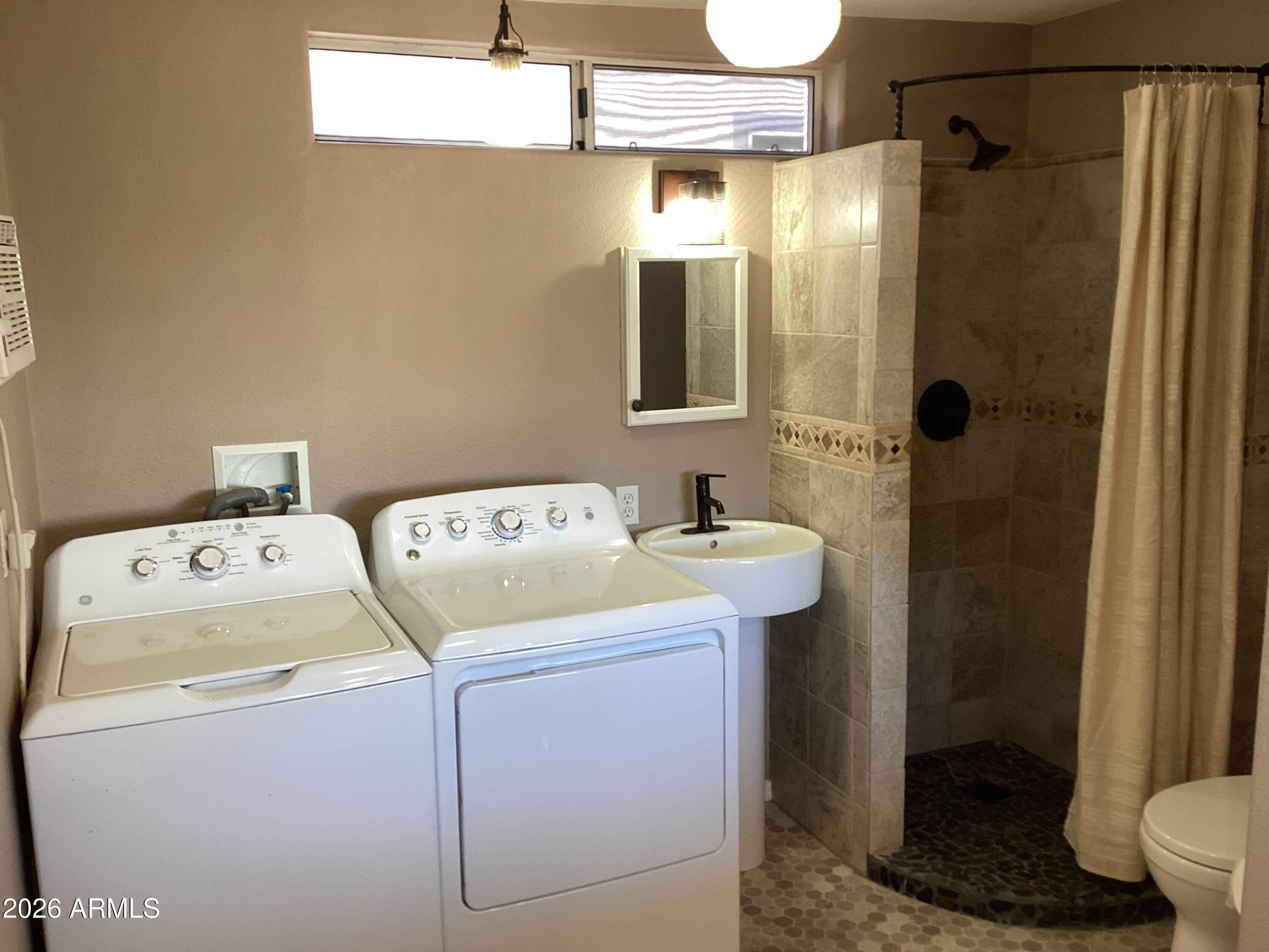 111 South Greenfield Road, Unit 163 Mesa, AZ 85206 - Photo 16 of 16 a bathroom with a sink a toilet and shower