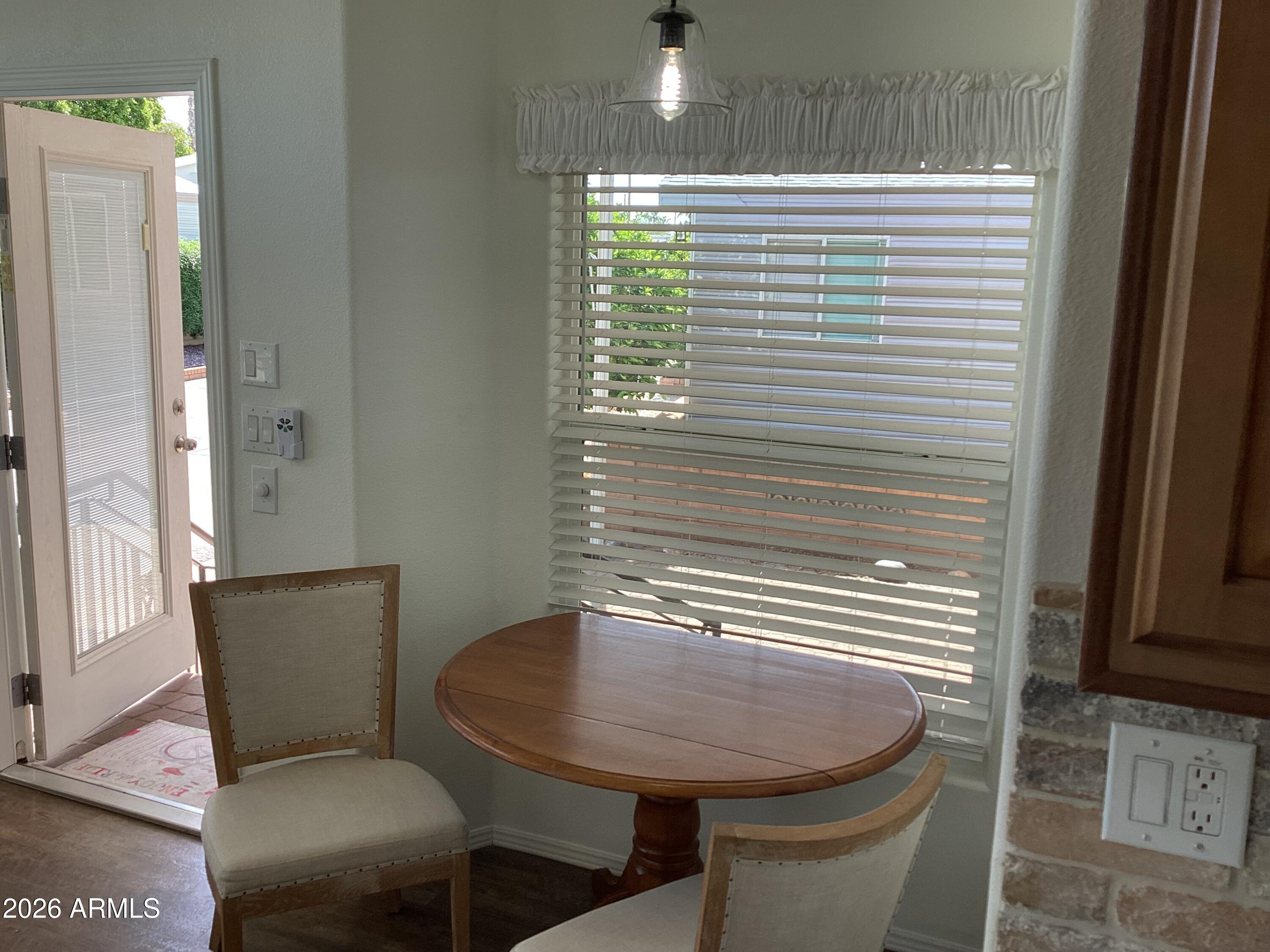 111 South Greenfield Road, Unit 163 Mesa, AZ 85206 - Photo 6 of 16 a view of a room that has a table and chair