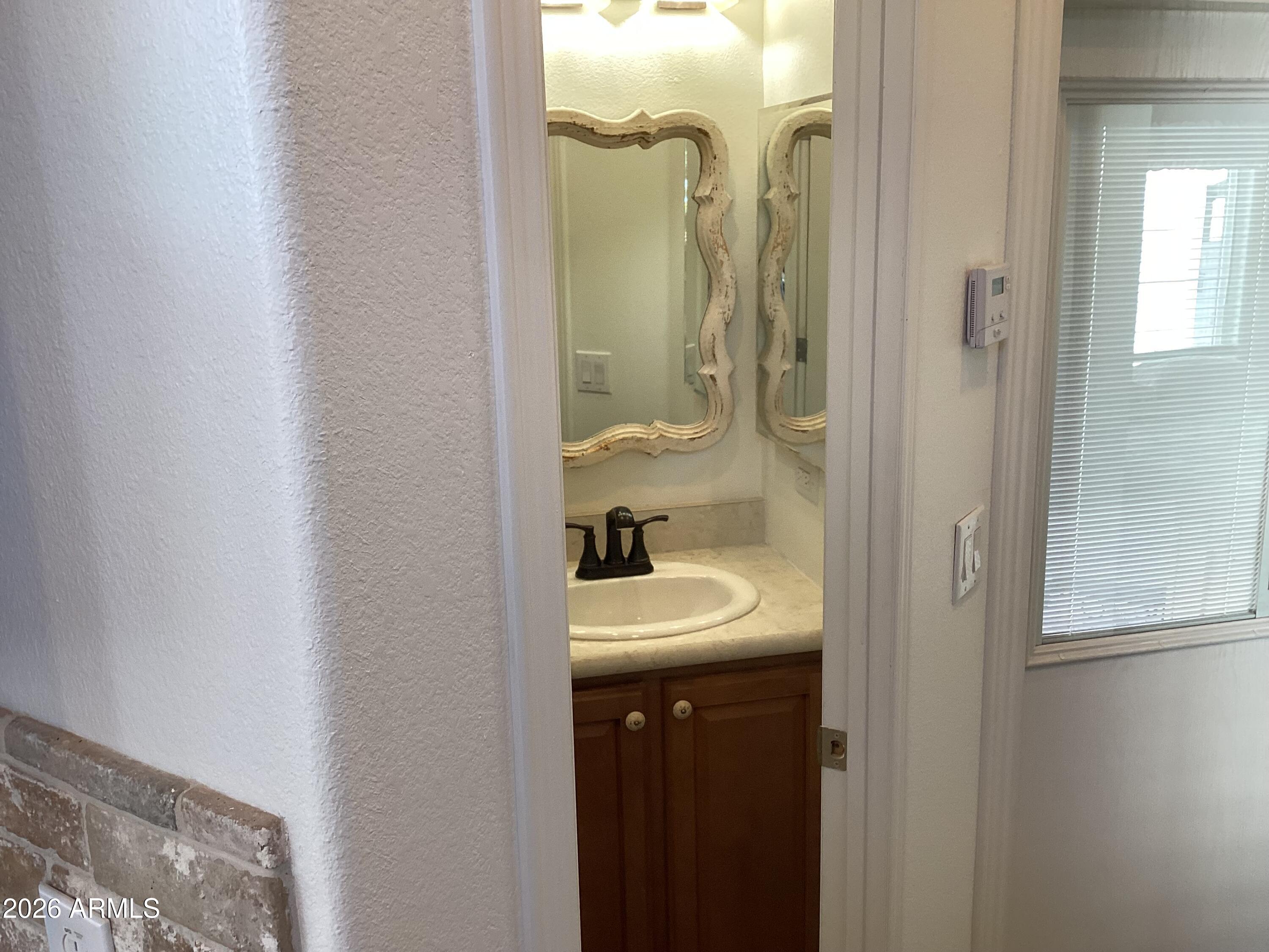 111 South Greenfield Road, Unit 163 Mesa, AZ 85206 - Photo 7 of 16 a bathroom with a sink and a mirror