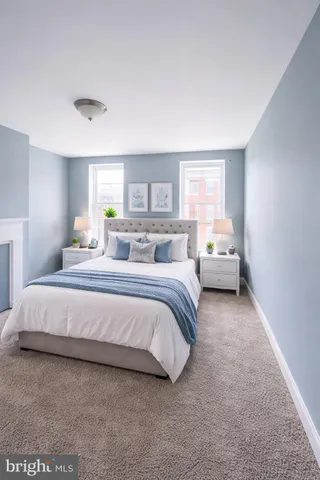 a spacious bedroom with a bed and window