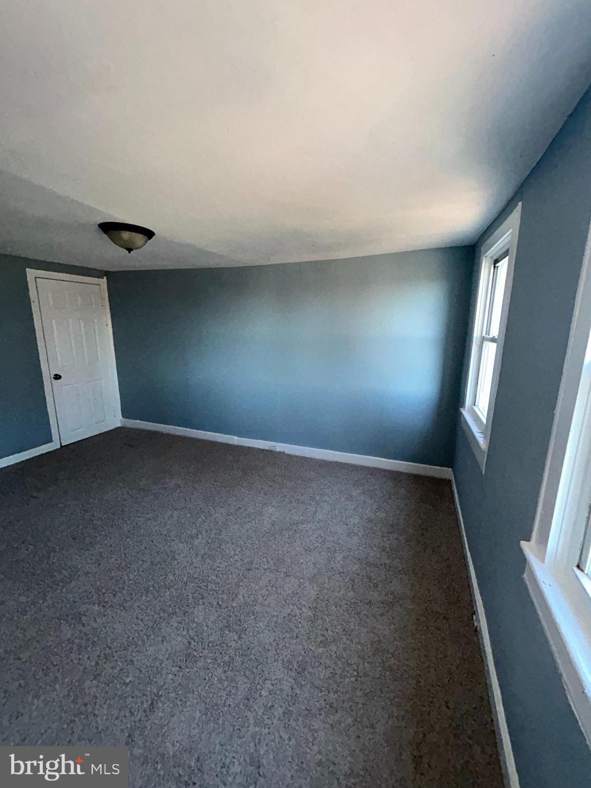 337 South Mount Street Baltimore, MD 21223 - Photo 15 of 16 wooden floor in an empty room with a window