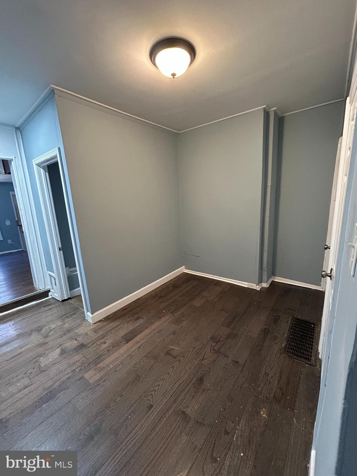337 South Mount Street Baltimore, MD 21223 - Photo 7 of 16 an empty room with wooden floor and windows