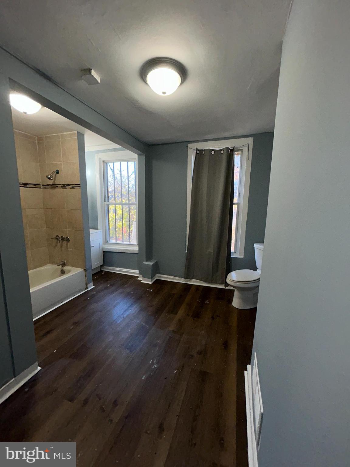 337 South Mount Street Baltimore, MD 21223 - Photo 8 of 16 wooden floor in an empty room with a window