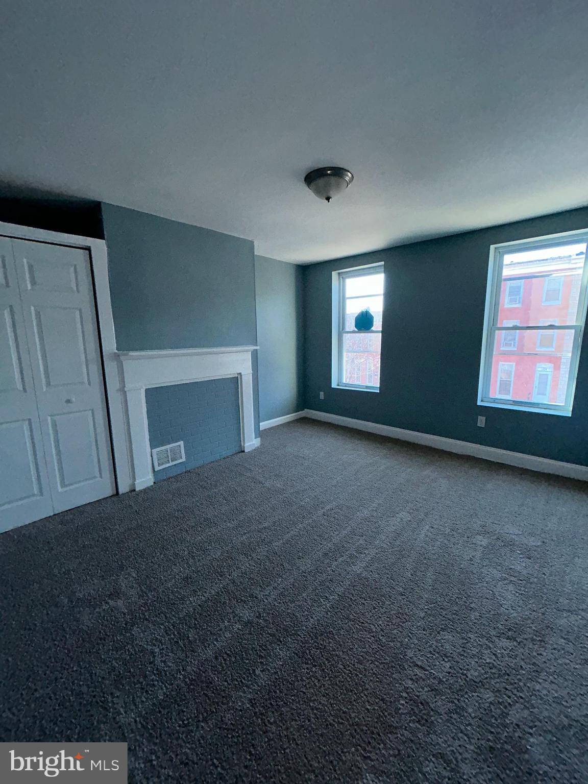 337 South Mount Street Baltimore, MD 21223 - Photo 9 of 16 a view of empty room with a fireplace