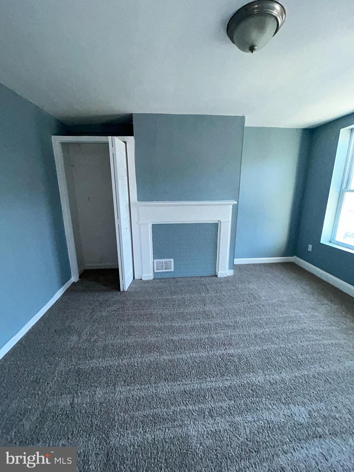 337 South Mount Street Baltimore, MD 21223 - Photo 10 of 16 a view of empty room with window and fireplace