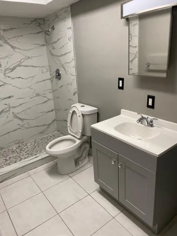 a bathroom with a sink toilet and mirror