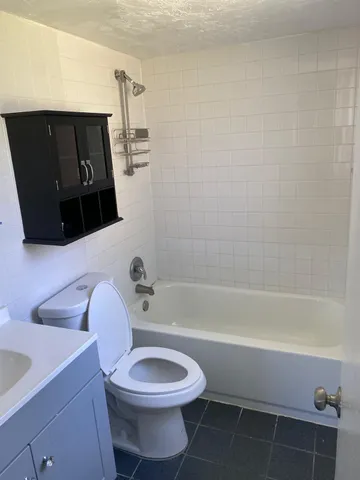a bathroom with a toilet a sink and bathtub