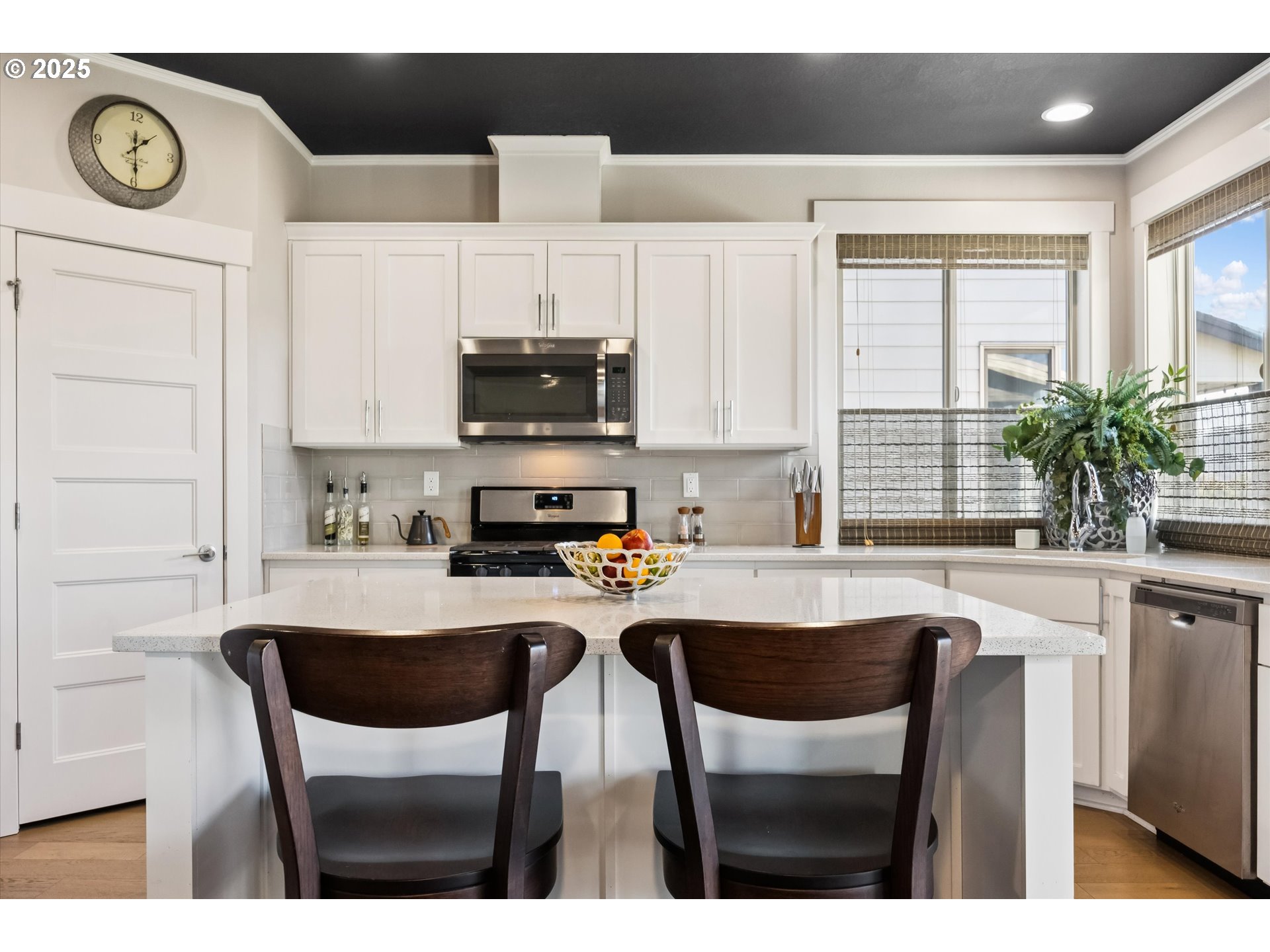 2440 Heather Way Forest Grove, OR 97116 - Photo 8 of 24 a kitchen with kitchen island granite countertop a sink cabinets and outdoor view