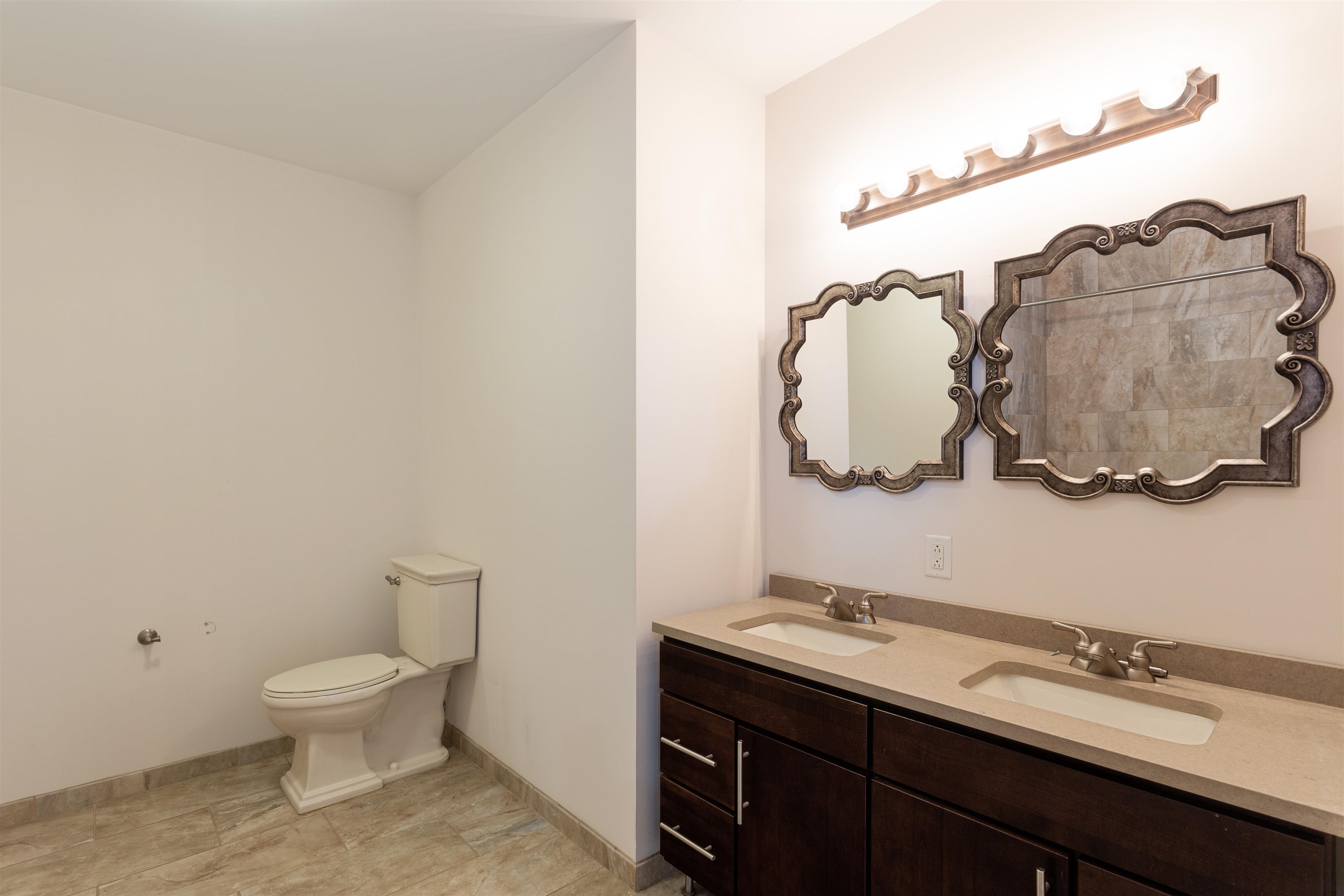 154 Ave East, Unit B407 Bayonne, NJ 07002 - Photo 10 of 19 a bathroom with a toilet sink and mirror