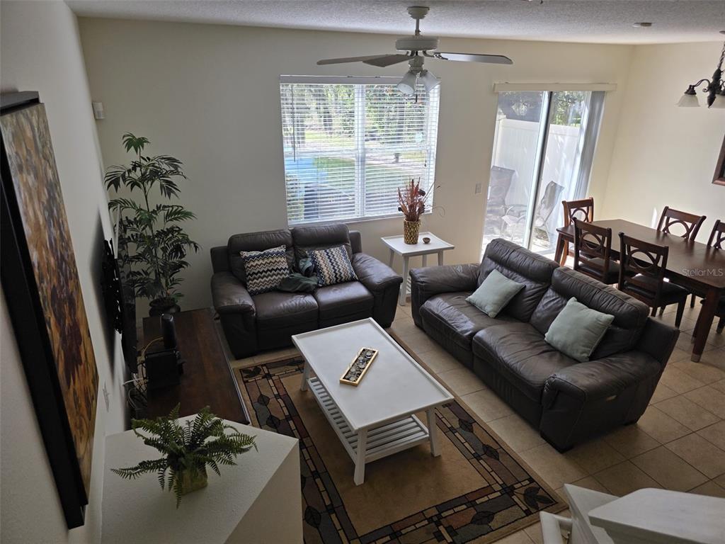 5160 Ambergris Loop Kissimmee, FL 34746 - Photo 11 of 38 a living room with furniture and a large window
