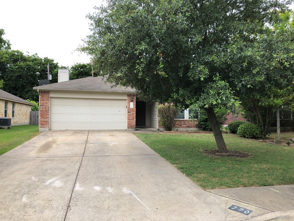 270 Buttercup Street Kyle, TX 78640 - Photo 1 of 1 a front view of a house with a yard and trees