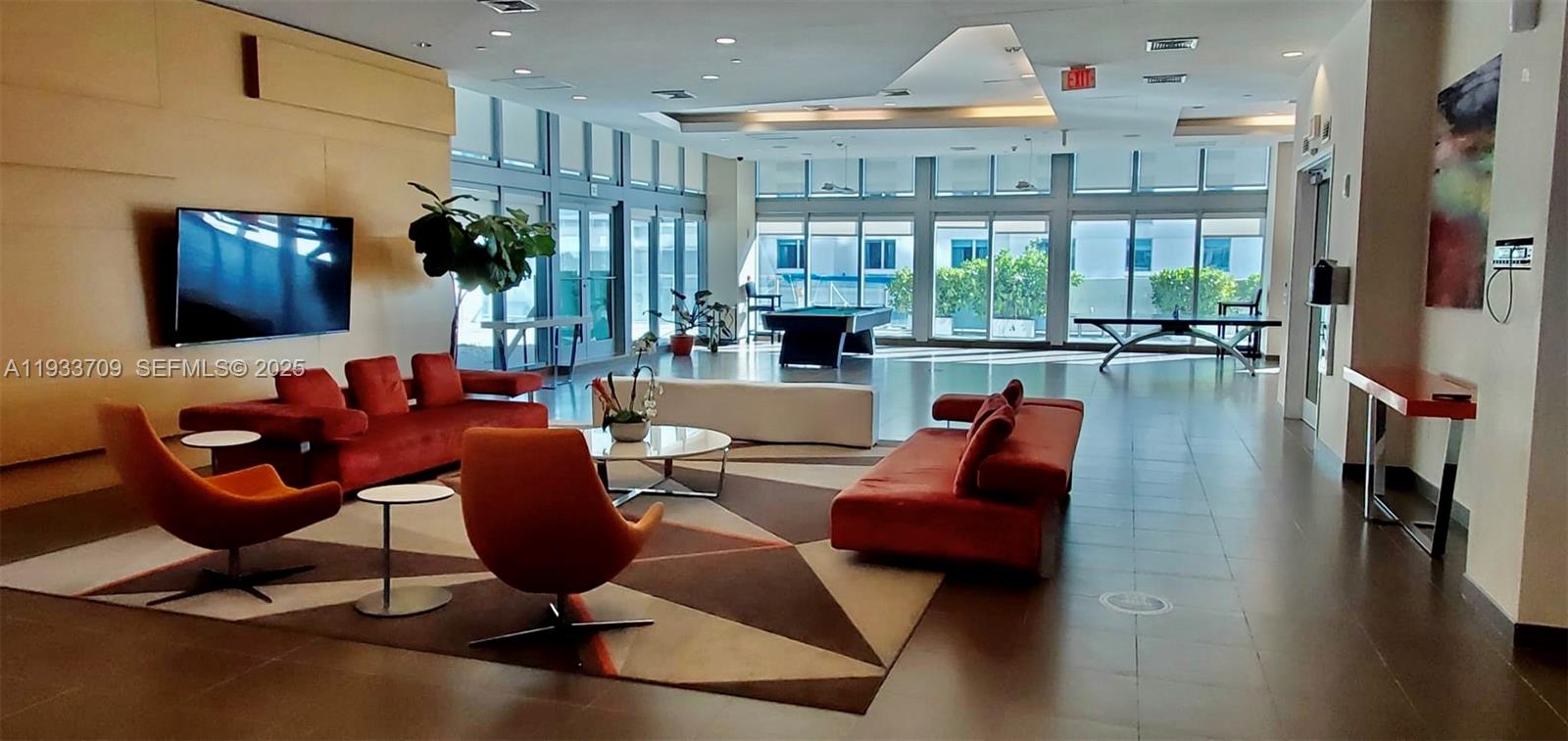 79 Southwest 12th Street, Unit 2411S Miami, FL 33130 - Photo 17 of 23 a living room with furniture fireplace and a large window