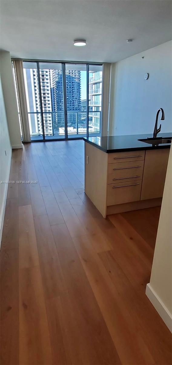 79 Southwest 12th Street, Unit 2411S Miami, FL 33130 - Photo 5 of 23 an empty room with wooden floor and windows