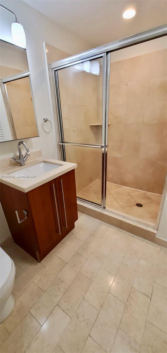 79 Southwest 12th Street, Unit 2411S Miami, FL 33130 - Photo 7 of 23 a bathroom with a sink and a mirror