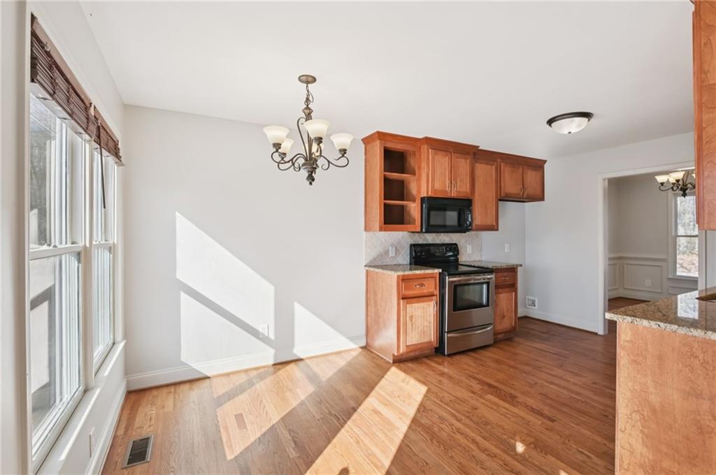 102 Oak Ridge Trail White, GA 30184 - Photo 11 of 31 a kitchen with stainless steel appliances granite countertop a refrigerator and a stove top oven