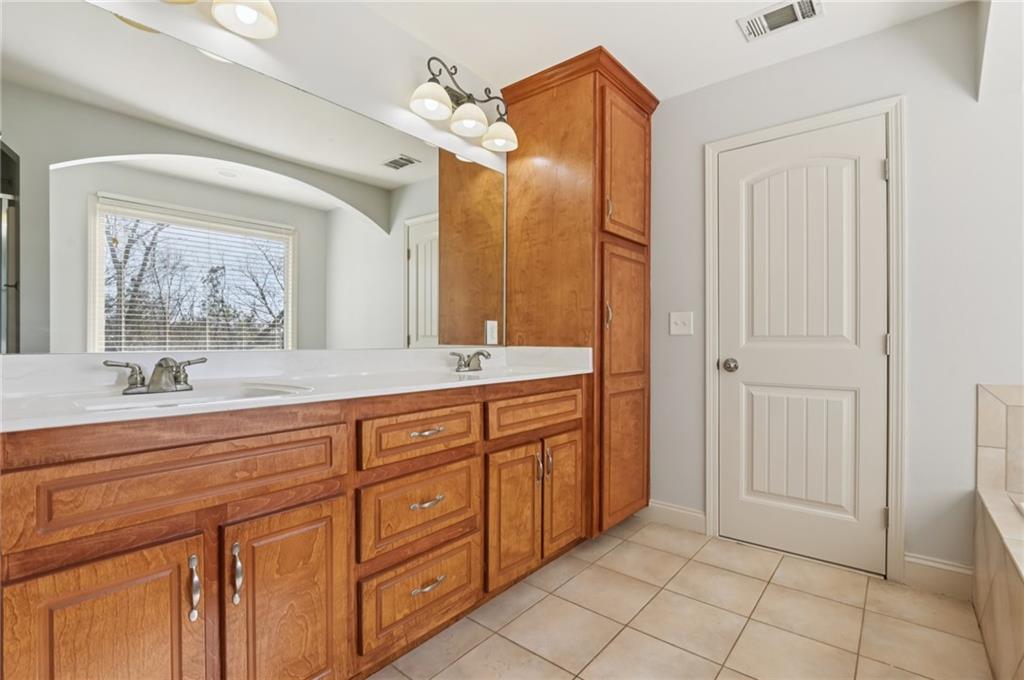 102 Oak Ridge Trail White, GA 30184 - Photo 17 of 31 a spacious bathroom with a granite countertop sink mirror and