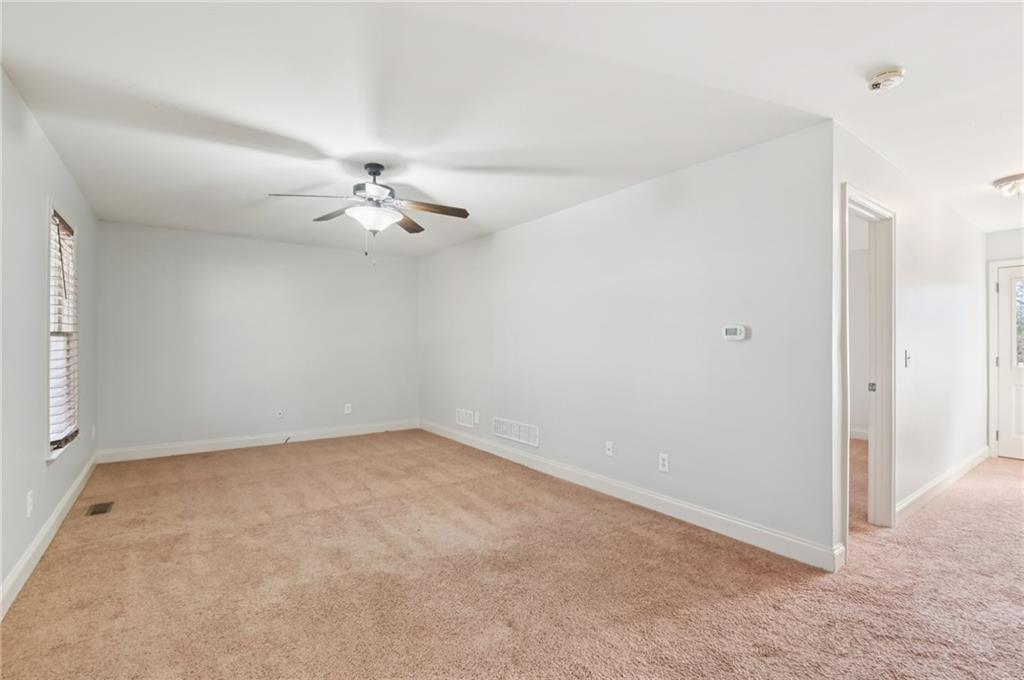102 Oak Ridge Trail White, GA 30184 - Photo 23 of 31 an empty room with windows and fan