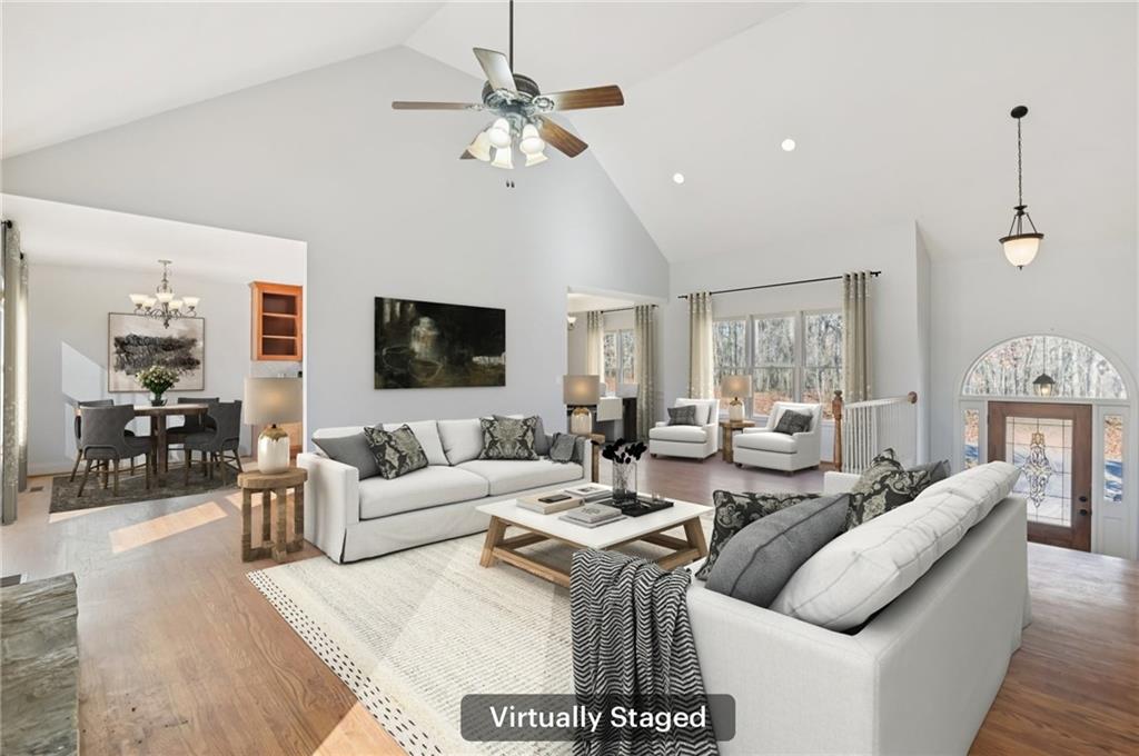 102 Oak Ridge Trail White, GA 30184 - Photo 4 of 31 a living room with furniture a chandelier and a flat screen tv