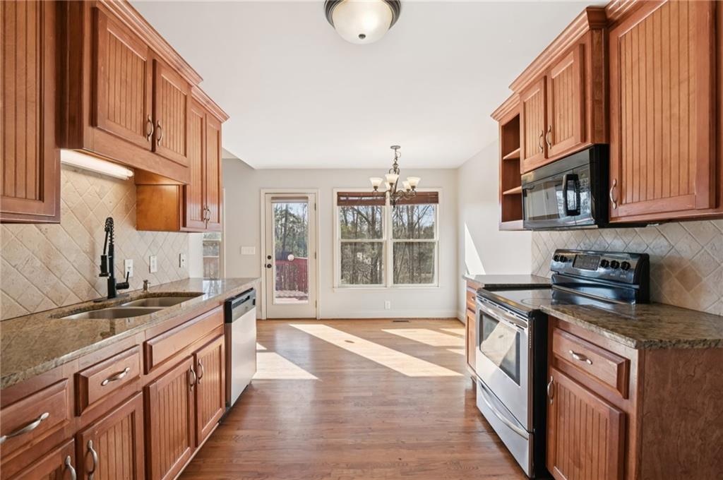 102 Oak Ridge Trail White, GA 30184 - Photo 9 of 31 a kitchen with stainless steel appliances granite countertop a stove a sink and a microwave