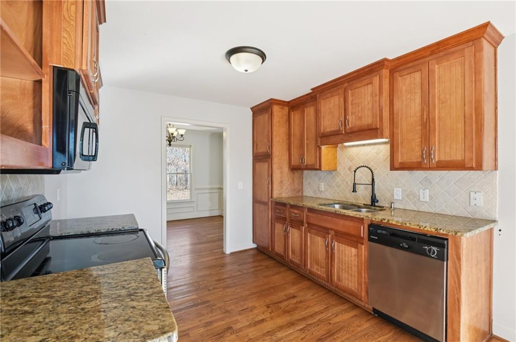 102 Oak Ridge Trail White, GA 30184 - Photo 10 of 31 a kitchen with stainless steel appliances granite countertop a sink stove and cabinets