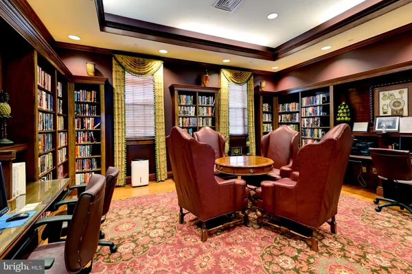 a view of a livingroom with furniture and a bookshelf
