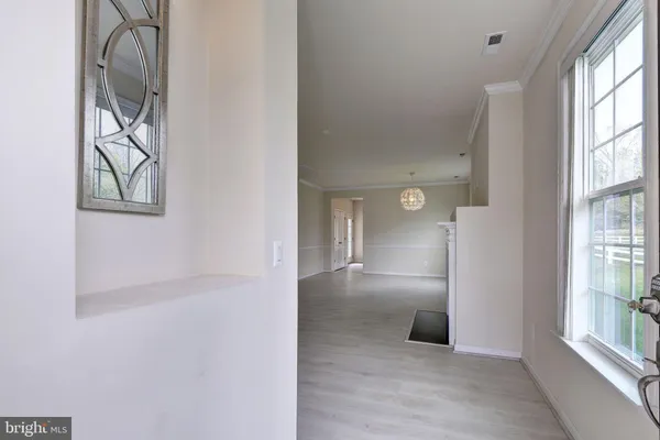 an empty room with windows and entrance